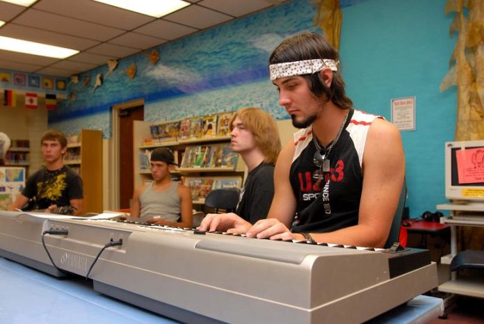 Josh Williams, right, along with other young musicians, from left, Jon Williams, Dylan Barnes, and Cody Patten, work on a composition Thursday, June 3, with Teen Power of Music teacher Barbara Hughes.