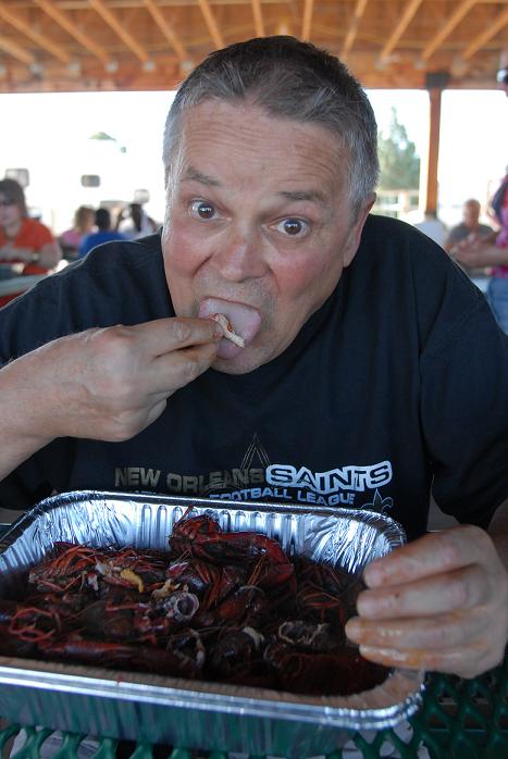 A native of Metarie, La., Village of Oak Creek resident Tom White talks about eating crawfish earlier this year in his home state while chowing down on a big plate of the freshwater crustaceans at the Camp Verde Crawdad Festival on Friday, June 4. Before sitting down to eat himself, White helped several people at his table figure out how to crack open the crawdads.