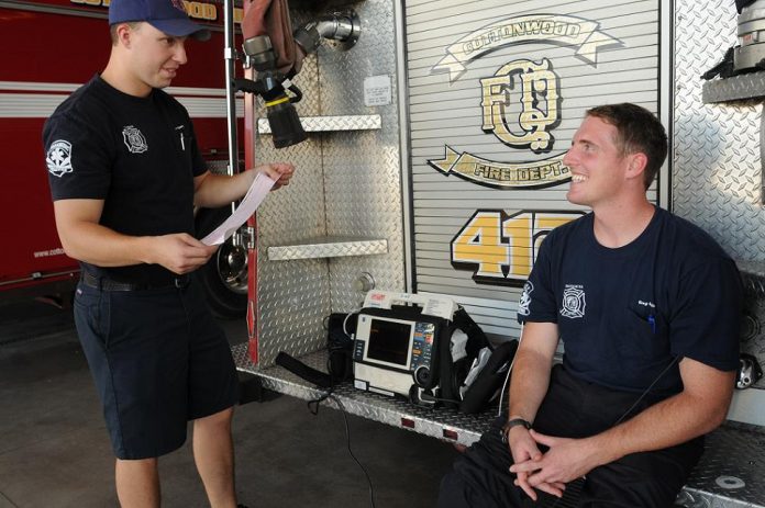 Lt. Shawn Kuykendall, left, a firefighter and paramedic with the Cottonwood Fire Department, explains a heart monitor printout Friday, Aug. 20, from a demonstration on firefighter Greg Gaiser of one of the advanced lifesaving skills paramedics are qualified to perform. Two CFD firefighters are now in school to become paramedics and two more begin classes in September, training which must currently be paid for by the firefighters themselves.