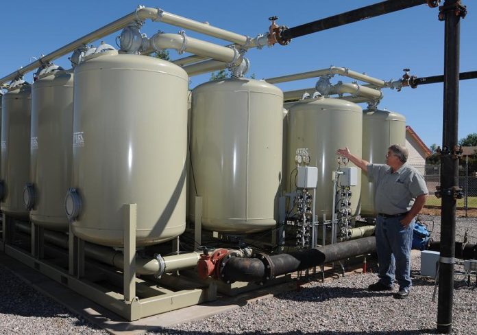 Roger Biggs, utilities administration manager for the city of Cottonwood Utilities Department, explains Thursday, Sept. 23, how newly installed filters decrease arsenic in the municipal water supply.