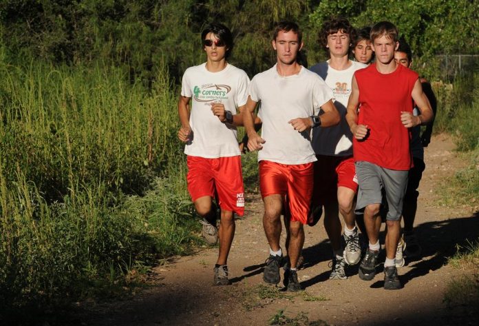 Runners on the Mingus Union High School cross country team jog down trails next to the Verde River behind Riverfront Park on Tuesday, Aug. 31 followed by the girls’ team coach, Lisa Rauch, on her bicycle. Boys’ team coach Jim Bostwick rides behind the faster runners.