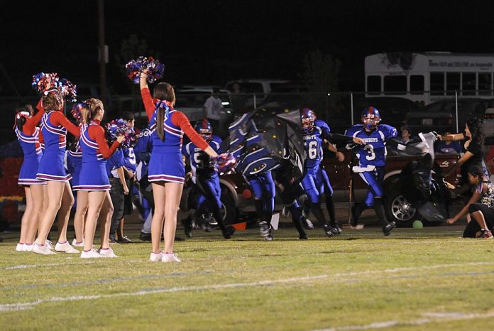 The Camp Verde High School Cowboys rush onto the field for the school’s homecoming football game Friday, Sept. 24. The Cowboys lost to Northwest Christian Academy, 28-0.