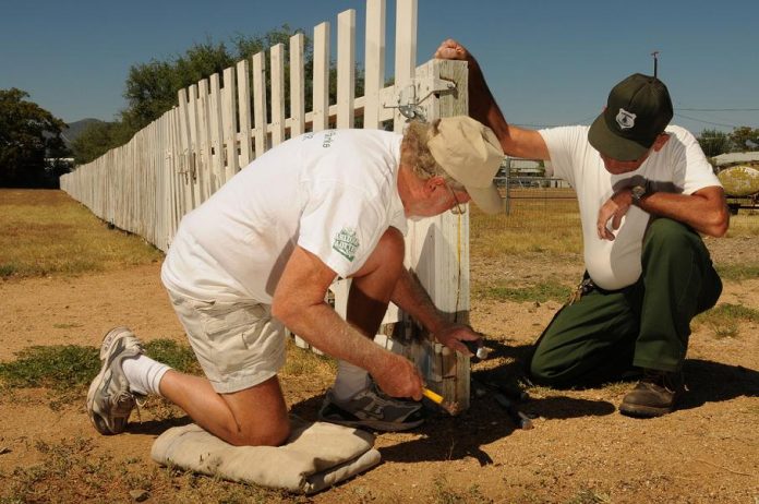 George Dvorak, bottom, a volunteer at Fort Verde State Historic Park, and seasonal ranger Bill Fritz repair a fence gate at the park Saturday, Sept. 11, in preparation for Tom Sawyer Day on Saturday, Sept. 25.