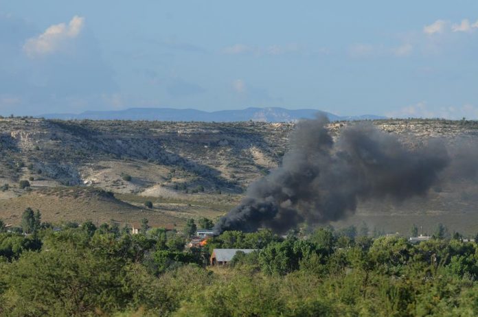 A house burning at the far western end of Middle Verde Road pumps black, acrid smoke into the air at approximately five p.m. on Tuesday, Sept. 21. Three women living in the home lost all of their possessions in the blaze but no people were injured.