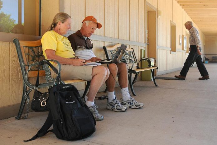 Josie and Bill Roberts, visitors to the Verde Valley from Florida, use the Camp Verde Community Library’s wireless Internet connection outside the building Sept. 1. The Camp Verde Town Council voted 5-2 later that evening to approve the start of an application process for a $1.2 million grant for the town’s library initiatives from the U.S. Department of Agriculture’s Rural Development agency.