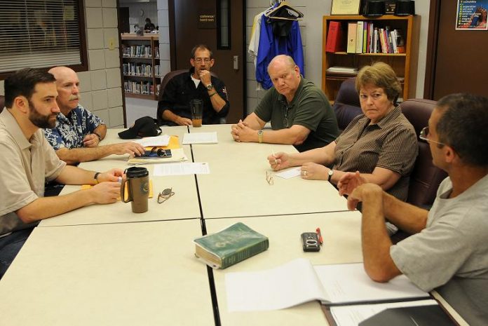 Camp Verde Unified School District Governing Board President Tim Roth, right, talks with local Christian leaders including, clockwise from left, Rev. Brian LeStourgeon, Rev. Kevin O'Neil, Trent Hackett, Rev. Wayne Speer and Ambie Charles during a meeting Friday, Sept. 17 in Superintendent Dan Brown's office about organizing released time for CVUSD students to spend studying the Bible.