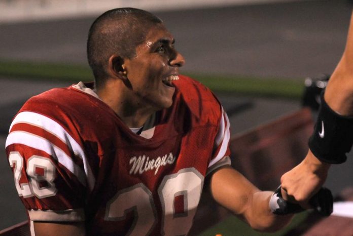 Running back Juan Gonzalez receives congratulations from his Marauders teammates after running for a 68-yard touchdown in the first half of a home game against Paradise Valley High School on Friday, Oct. 1. Mingus shut out the Trojans, 42-0.