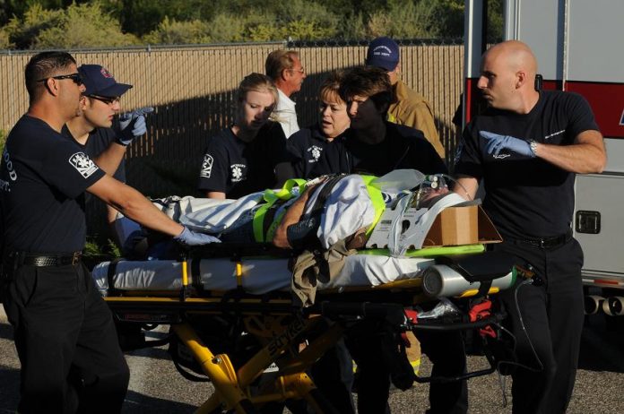 One of at least THREE injured passengers from a hot air balloon involved in a collision with a paraplane is treated by firefighters and paramedics shortly after the early morning start to the Cottonwood Airfest on Saturday, Oct. 16.