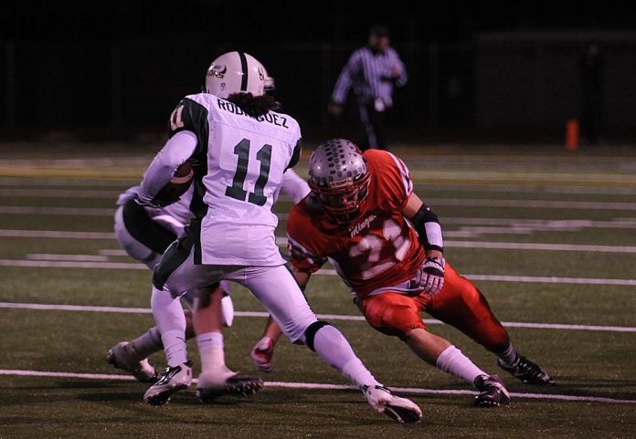 Senior Eric Quesada comes down with a catch Friday, Nov. 12 (above). Senior Logan Couch goes for a tackle in the first round of the 4A-II conference state playoffs against Greenway High School (right). The Mingus Union High School football team won, 28-21. Mingus is scheduled to play Notre Dame Preparatory in round two Friday, Nov. 19, at 7 p.m.