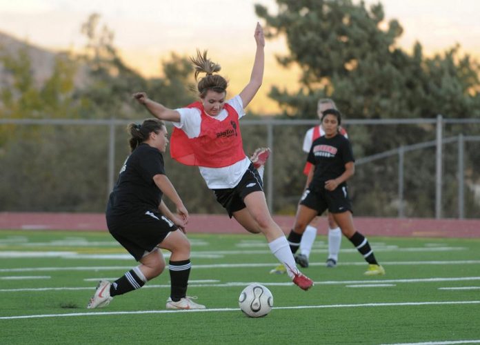 McKenzie Mabery leaps around a North Canyon High School player to take the ball during a Mingus Union High School varsity girls soccer scrimmage Nov. 17. The Marauders won the 4A-II conference state championship last season over Flagstaff High School, 1-0.