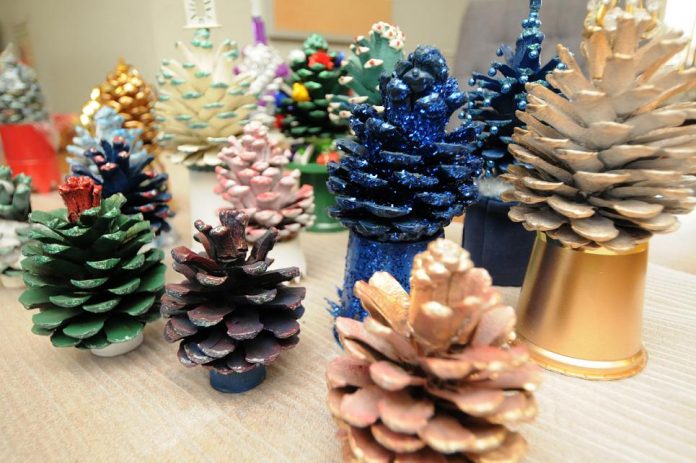 Pinecones decorated by Richard Corey will be on display at the Cottonwood Public Library through December. Corey said the simple craft helped him regain his holiday spirit.