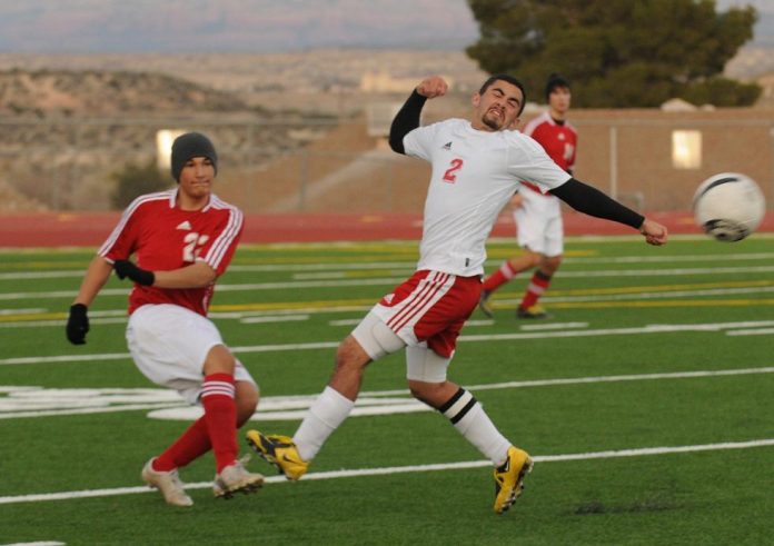 Mike Rebstein, a senior forward on the Mingus Union High School boys soccer team recoils from a kick from a Bradshaw Mountain High School player during a home match Tuesday, Jan. 11. Mingus won, 2-1.