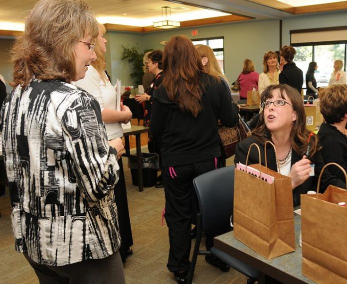 Heather Yorba, third from right, chats with former colleague Beverly Newton, left, at the Professional Women’s Group health fair and networking luncheon at the Cottonwood Recreation Center on Jan. 18.