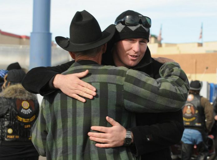 Lance Cpl. Andrew Brooks, a Marine whose homecoming was celebrated by the American Legion Riders in Camp Verde on Sunday, Jan. 2, gives a hug to a friend. The local motorcyclists routinely sponsor homecoming rides for soldiers finishing their tours or simply home on leave.