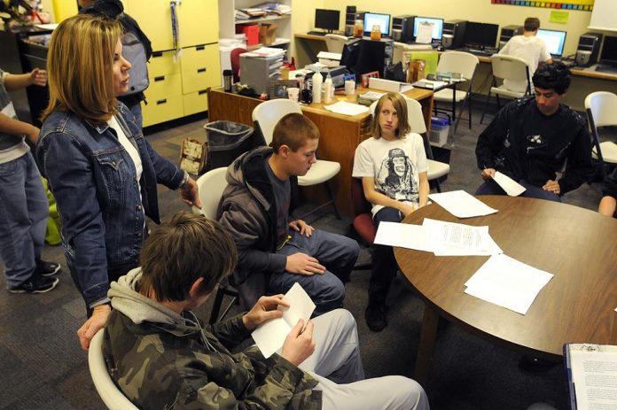 Genna Adams, left, talks with her Language Arts Enrichment students about their paper on life’s challenges during class time Thursday, Jan. 27. Adams is an organizer of the Tuesday, Feb. 8, “Rachel’s Challenge” assembly aimed at decreasing bullying and boosting empathy among the student body and her students are exploring the topic within the class curriculum.