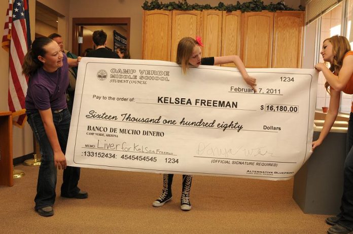 Kelsea Freeman, 12, center, points Friday, Feb. 11, to the significant amount of money raised during a recent spaghetti dinner and auction organized by the Camp Verde Middle School student council including President Danya Weir, left, and reporter Sharli MacDonald.