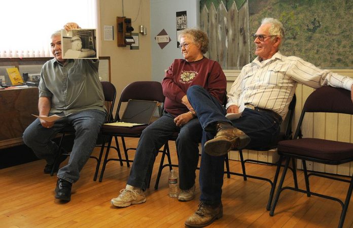 Cottonwood High School alumni, from left, Frank Fuqua, Janet Cluff and Don Godard, talk about their high school experiences at a reunion of sorts in the Clemenceau Heritage Museum, formerly the school, on Friday, March 25. The building functioned as the Cottonwood High School from 1947 until 1958.