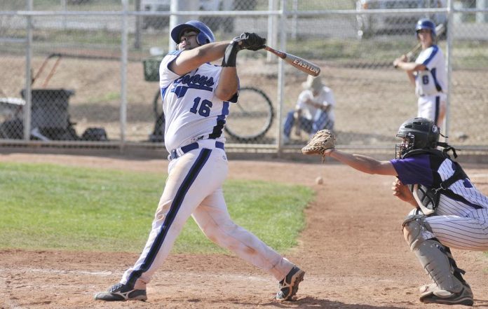 Junior catcher Andy Minner swings at a pitch March 17. Minner hit a three-run home run against Northland Preparatory Academy on Thursday, March 31, in a 14-3 victory. Minner and the Cowboys struggled Saturday, April 2, in a 13-1 loss.