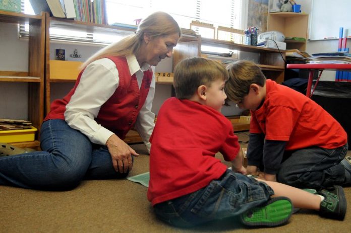 Elaine Anderson, founder of St. Joseph’s Catholic Montessori School, works with students Monday, May 9. Anderson plans to retire her 40-year education career at the end of the 2010-2011 school year.