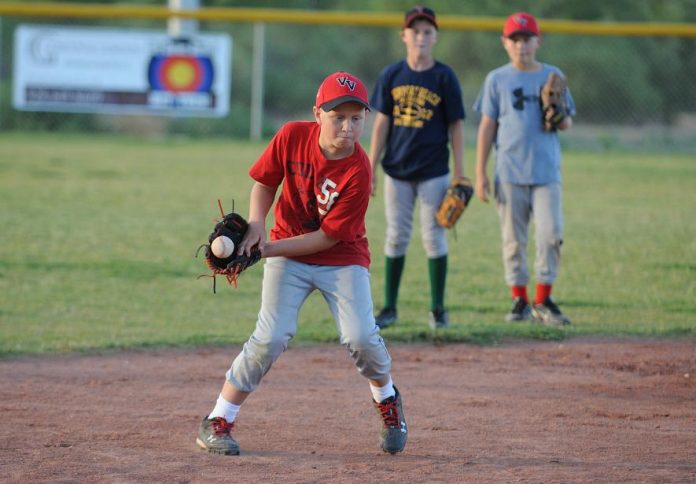 Andrew Kulis, left, scoops up a ground ball during defensive drills for the Verde Valley All-Stars [ages 10 to 11] practice at Riverfront Park on Friday, June 17.