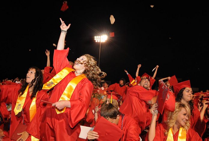 The MARAUDERS class of 2011 erupts after turning their tassels to the other side of the mortarboards at the Mingus Union High School commencement ceremonies at Bright Field on Friday, May 27.