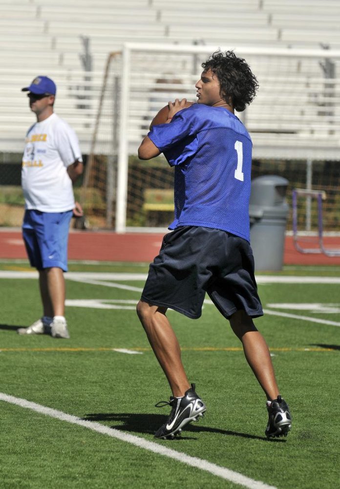 Quarterback Deshon Tripp looks for an open man downfield Saturday, June 25, during a seven-on-seven tournament in Sedona. Tripp is expected to be the starting quarterback come fall for the Cowboys.