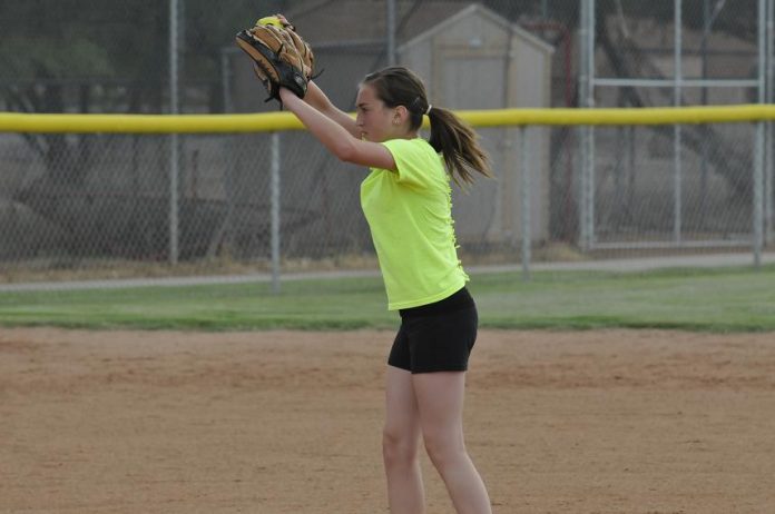 Pitcher Kaycee Williams of the Verde Valley Heat 12 and under team warms up with some pitching before practice begins Thursday, July 11. The team focuses on fundamentals and helps the girls prepare for competition.