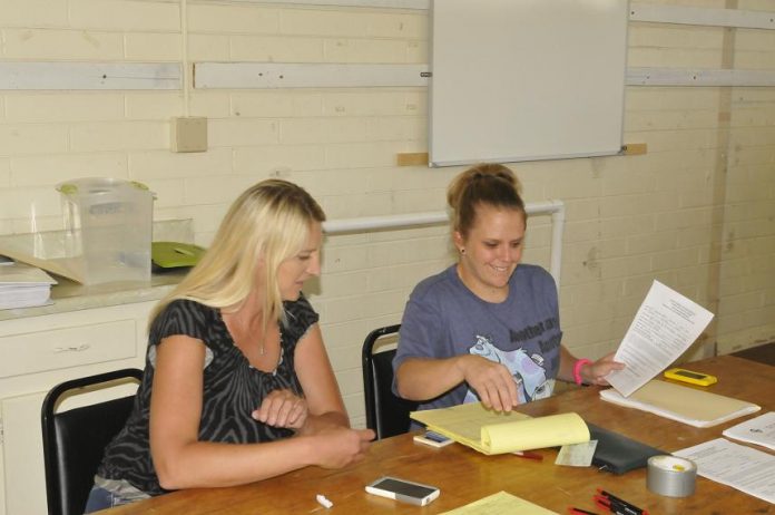 Jacqui Hedges, left, and Deanna Boggess stayed busy at town hall Saturday, July 27. The pair signed players up for the new season of the youth football league.