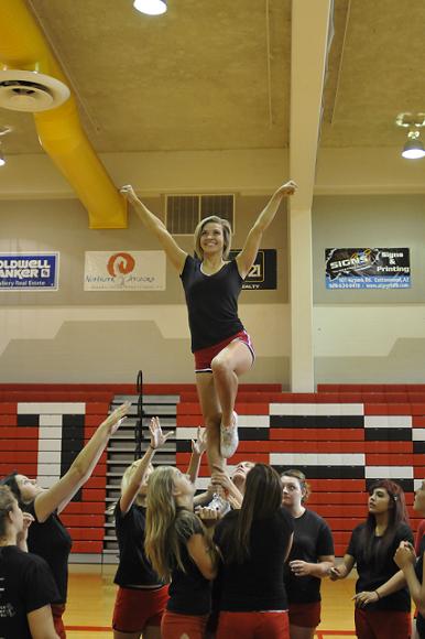 Allison Whitworth performs atop her teammates' shoulders at the Mingus Spiritline's practice on Friday, Aug. 9.