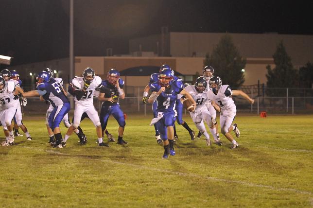 Bodie Holowell runs away from tacklers in Camp Verde's game against Scottsdale Prep on Friday, Sept. 13 at Sam Hammerstrom Field in Camp Verde.