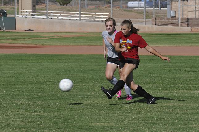 Paige Church, right, of the Camp Verde girls soccer team manages to get a shot past teammate Emma Ehresman during team drills at the high school Wednesday, Aug. 28.