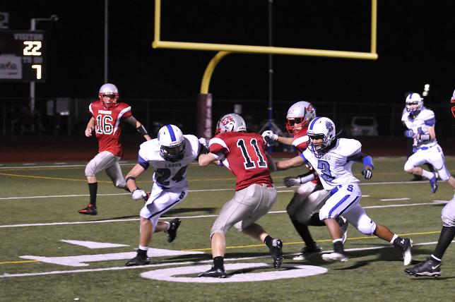 Brennan Kitchen, No. 11, of the Mingus Marauders attempts to split the Snowflake defenders on a run toward the end zone in their game Friday, Aug. 30 in Cottonwood.