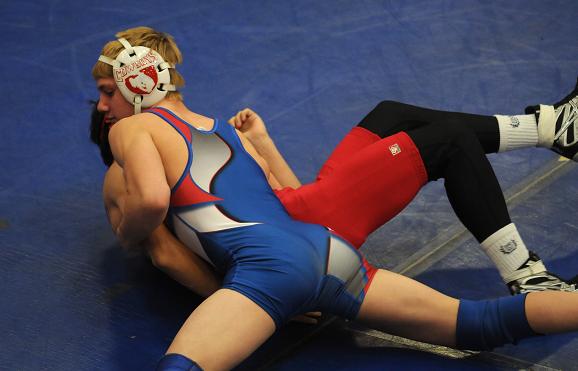 Cowboys junior and two-time state champion Ryan Allred pins an opponent in a match last season.