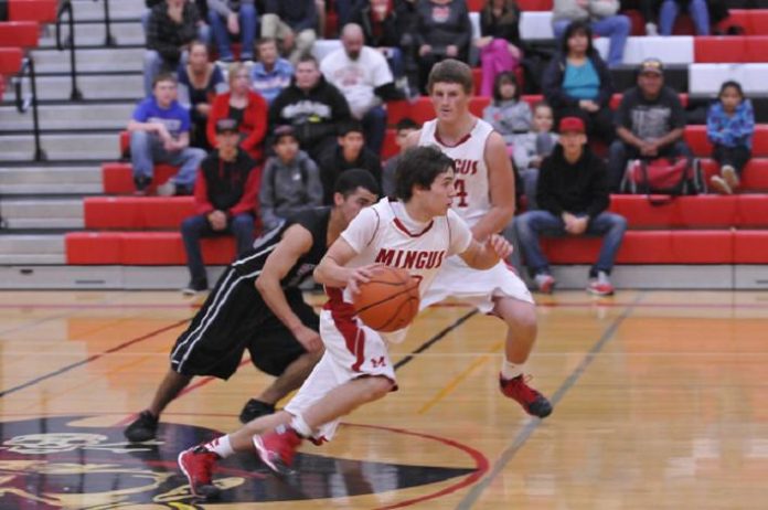 Sophomore Tristan Clark drives past a defender in Mingus Union High School’s home boys basketball game against the Sedona Red Rock High School on Dec. 3. Sophomore Tristan Clark drives past a defender in Mingus Union High School’s home boys basketball game against the Sedona Red Rock High School on Dec. 3.