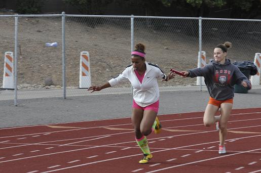 Senior Justine Taylor trains for a 4x100 relay at Mingus Union High School with her partner, freshman Auli Hanks, on Thursday, March 27. Taylor is defending Division III state champion in the 4x800 relay; her 4x100 relay team finished second at the state championships in May.