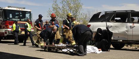 The “victim’s” body is put on a gurney, as the specter of Death looms over, in a macabre bit of theater, meant to teach a lesson to students on Thursday, April 10, at Mingus Union High School. Cottonwood firefighters and police narrated a mock fatal crash caused by drunk driving. The mock accident was laid out as part of the Every 15 Minutes campaign.