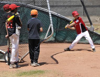 Cole Gillespie, right, steps up to bat Tuesday, May 27, at a batting camp at Mingus Union High School. The camp, run by MUHS head baseball coach Bob Young, aims to improve the ability of boys and girls ages 6 through 14 to connect with the ball, pitched by Young in the sixth and final “live” station.
