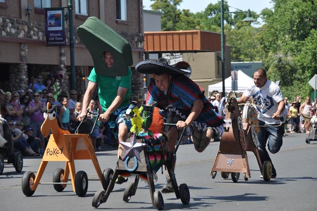 Jakob Carter, in the sombrero, beats Gumby [Ryan Taylor] to the finish line in a preliminary heat of the "Run for the Roses Cottonwood Bottleg Derby" on Saturday, May 3.