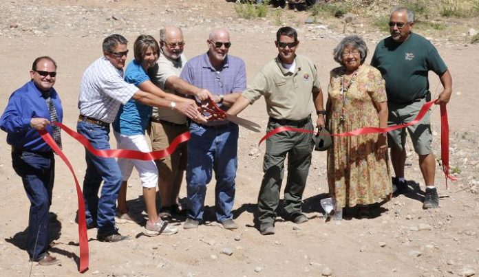 Clarkdale held its grand opening of the Lower TAPCO River Access on June 18. The ceremony came to a close with the ribbon cutting, officially marking the access point as open. Town Manager Gayle Mabery, third from left, opened the ceremony.