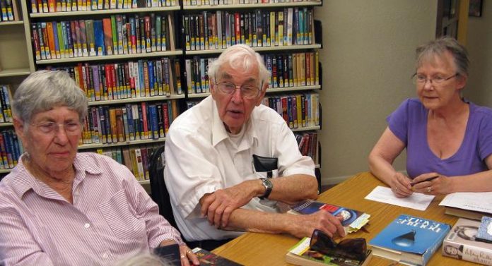 BABE DALEY, John Jenkins and Amber Polo, left to right, discuss books as part of adult programs at the Camp Verde Community Library. Polo will lead the new writers group at the library.