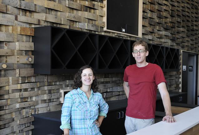 Director of Viticulture and mayor of Jerome Nikki Check stands with Enology Director Michael Pierce in the tasting room of Yavapai College’s new Southwest Wine Center. The back wall was made from old wine barrels. The college recently received a grant that will assist both the wine center and tech education.