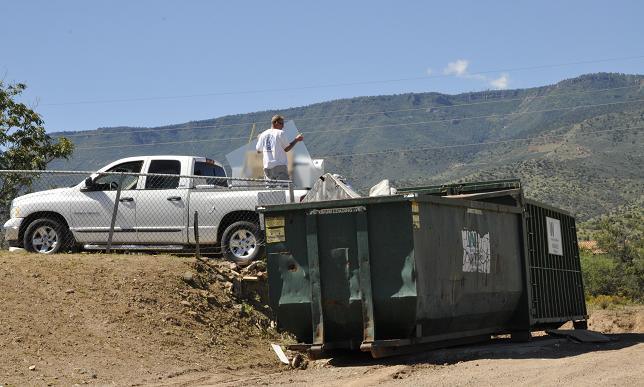 A contractor empties construction waste into a Dumpster at Cottonwood’s Transfer Station. Until recently, the transfer station would not accept construction refuse from commercial contractors, instead sending them out of town. Now, however, they will take contractor’s refuse in small quantities.