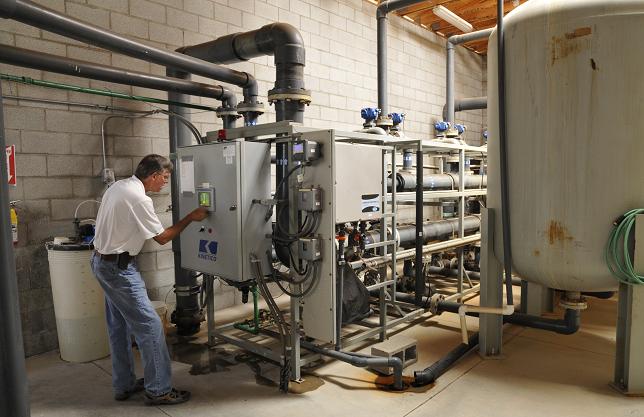 Utilities Director Wayne Debrosky checks Clarkdale’s arsenic removal facility, which filters water before it is piped to consumers. This expense is one reason the town has increased its utility rate.