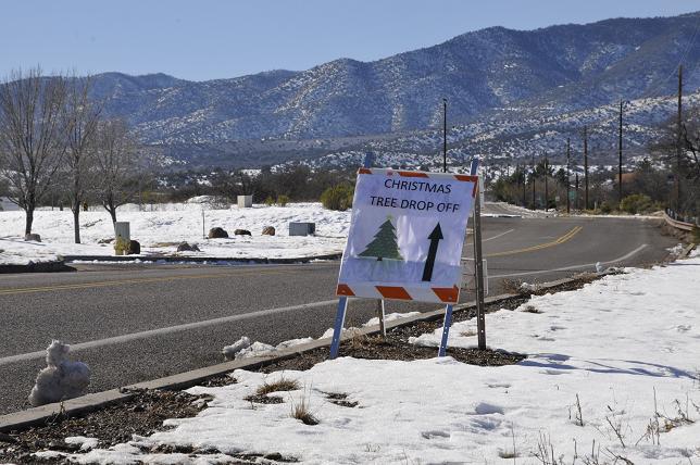 Signs point the way down Mingus Avenue to where the city of Cottonwood has designated a spot for collecting discarded Christmas trees.