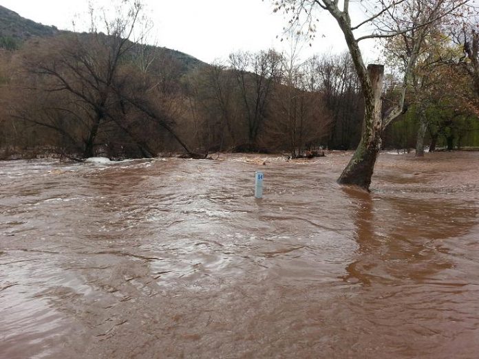 Oak Creek temporarily claimed several RV lots at Sunrise Resort’s Page Springs campground on Sunday. The water level is about two-feet deep on the post for lot 54, where RV owners plug in for electrical service when camping. A few days of rain in the Verde Valley funneled into the creek, swelling it beyond its usual boundaries. About the time this photo was taken, an Arizona Department of Transportation truck was parked on the shoulder of Page Springs Road and its driver was taking a look at the bridge and powerful current beneath it about 100 yards downstream from the RV campground.