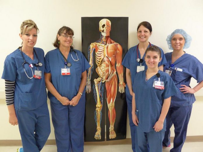 Surgical Services staff members stand with a prop they will be displaying during the operating room open house. From left are nurses Jennifer Moore, Sara Walton, Sue Lovett, operating room technician Brittany Burns and nurse Jordan Allen.