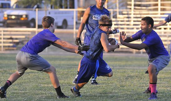 Camp Verde High School hosted a seven-on-seven football camp this summer: a two-hand touch football game with seven players on each team. Cowboy senior Kyle Little catches a pass and makes significant yardage.