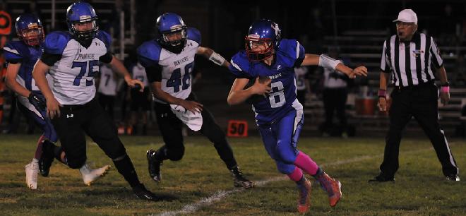 Camp Verde High School sophomore quarterback Payton Sarkesian evades oncoming defenders in the Cowboys’ 54-6 loss to visiting Paradise Honors High School on Senior Night Oct. 23. Sarkesian ran for 56 yards and passed for 180 yards.