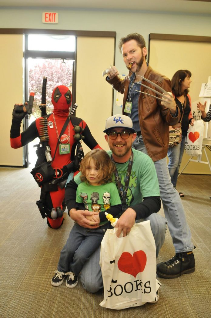 Nathan Getz and son Oliver, 2, got a chance to pose with two Marvel Comics super heroes at the Verde Valley Comic Expo on April 9. On the left is Deadpool, the Merc with a Mouth, and on the right is Wolverine, the best there is at what he does.