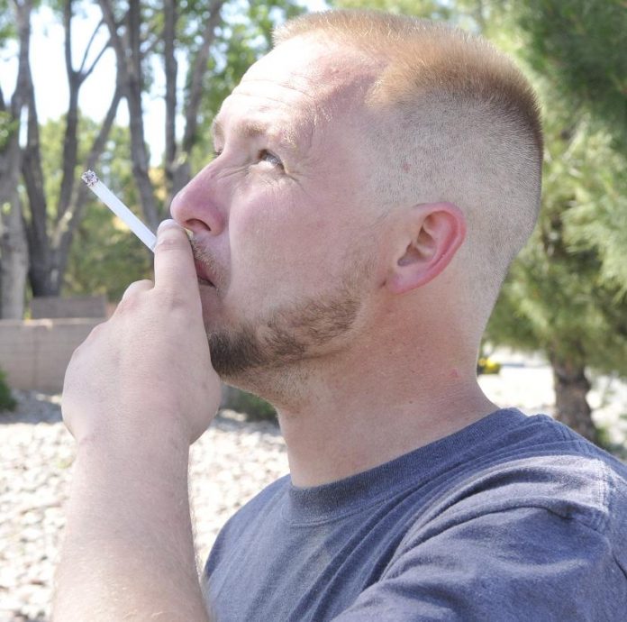 Brandon Willden puffs on a cigarette. Cottonwood recently passé an ordinance upping the age of sale of tobacco and vapor products from 18 to 21.